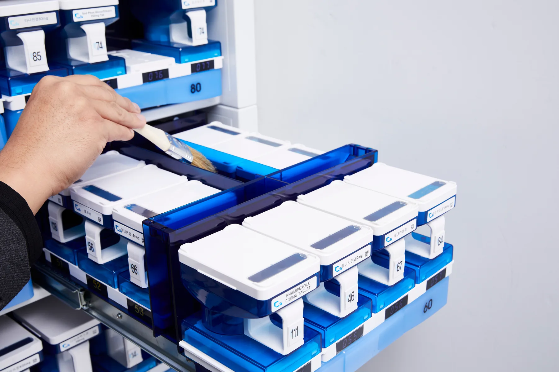 Technician replenishing a drug cassette on the T-slide drawer